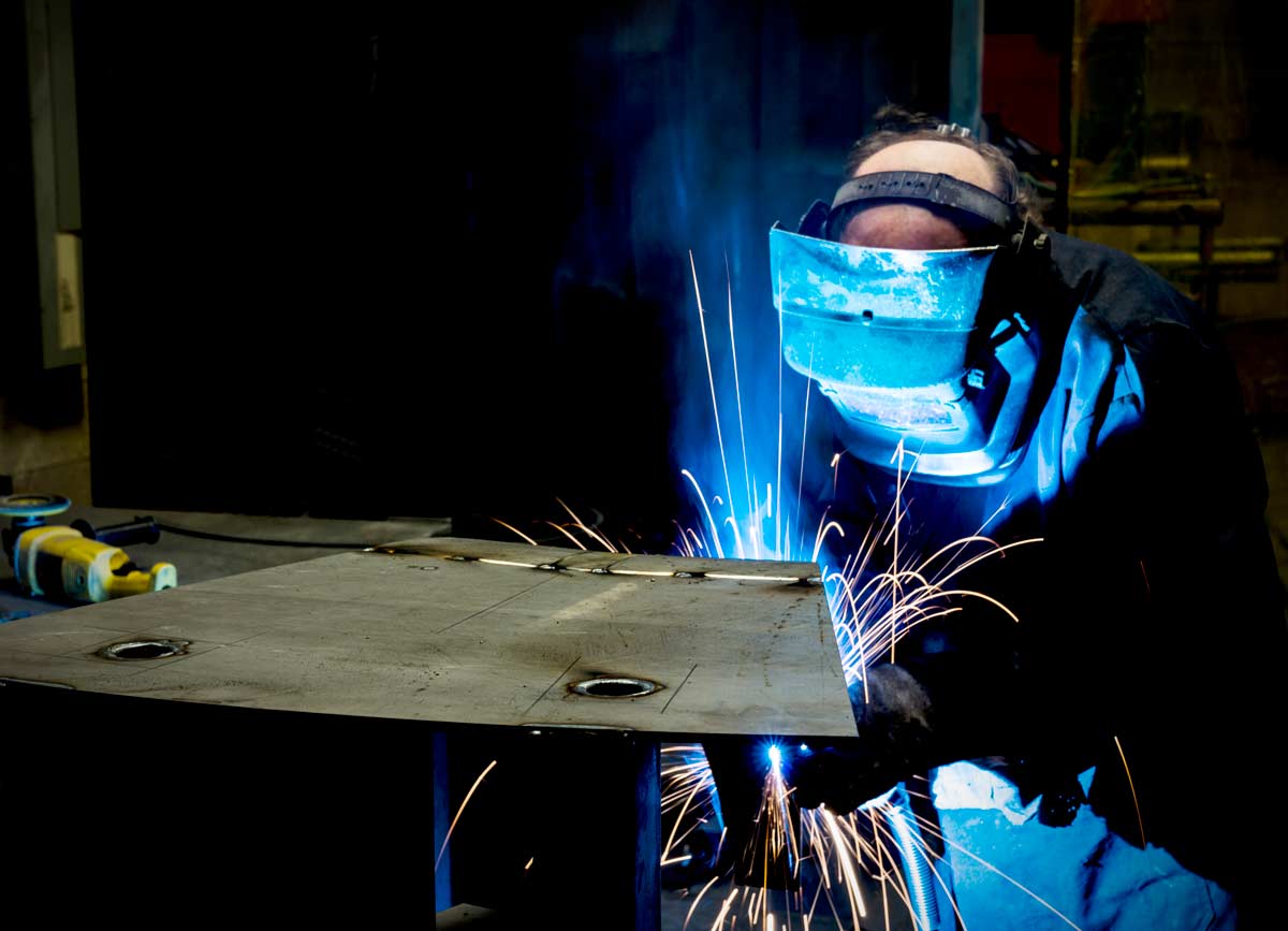 Man spot welding at Spike Electric in Houston, TX