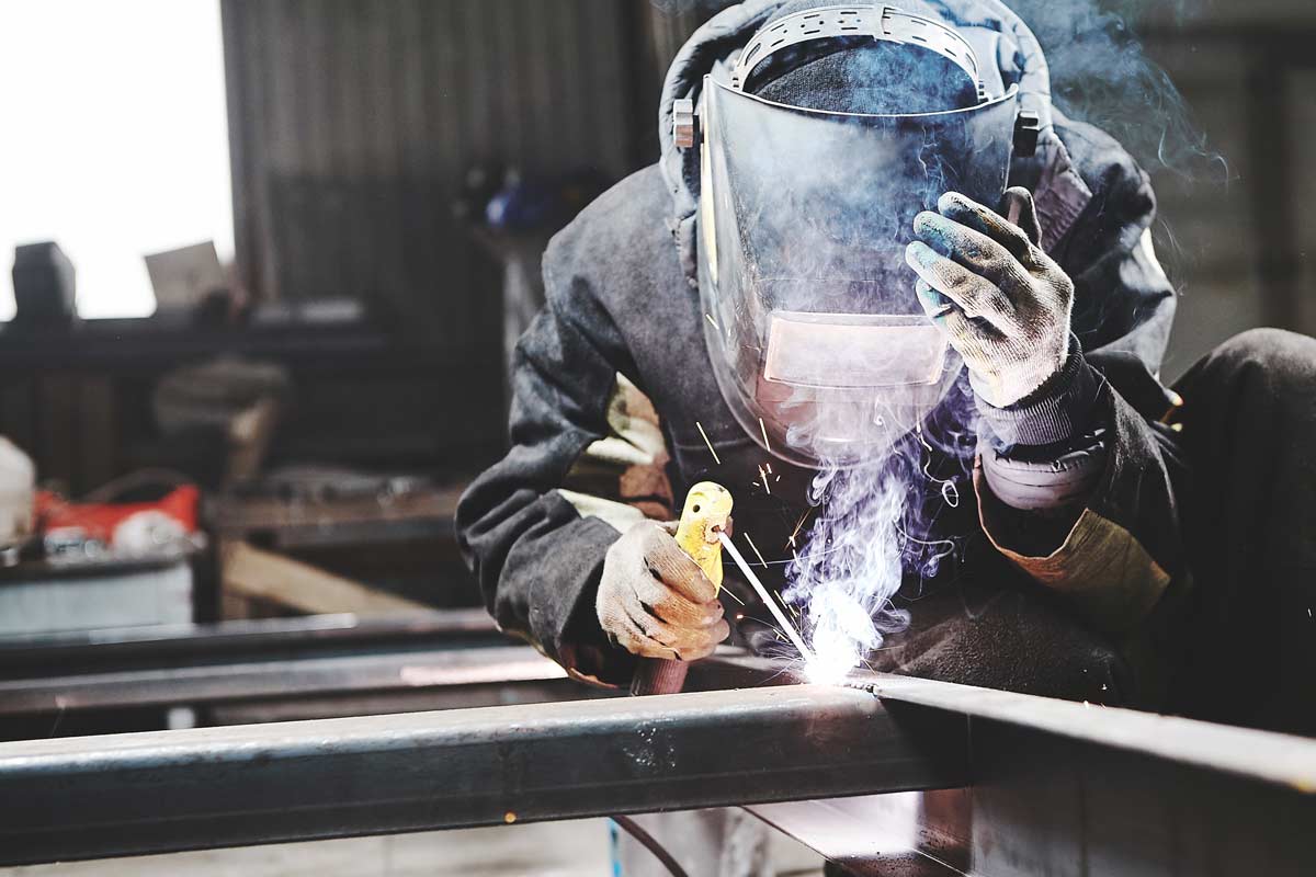 welding-man-welding-mask-spike-electric man welding at spike electric