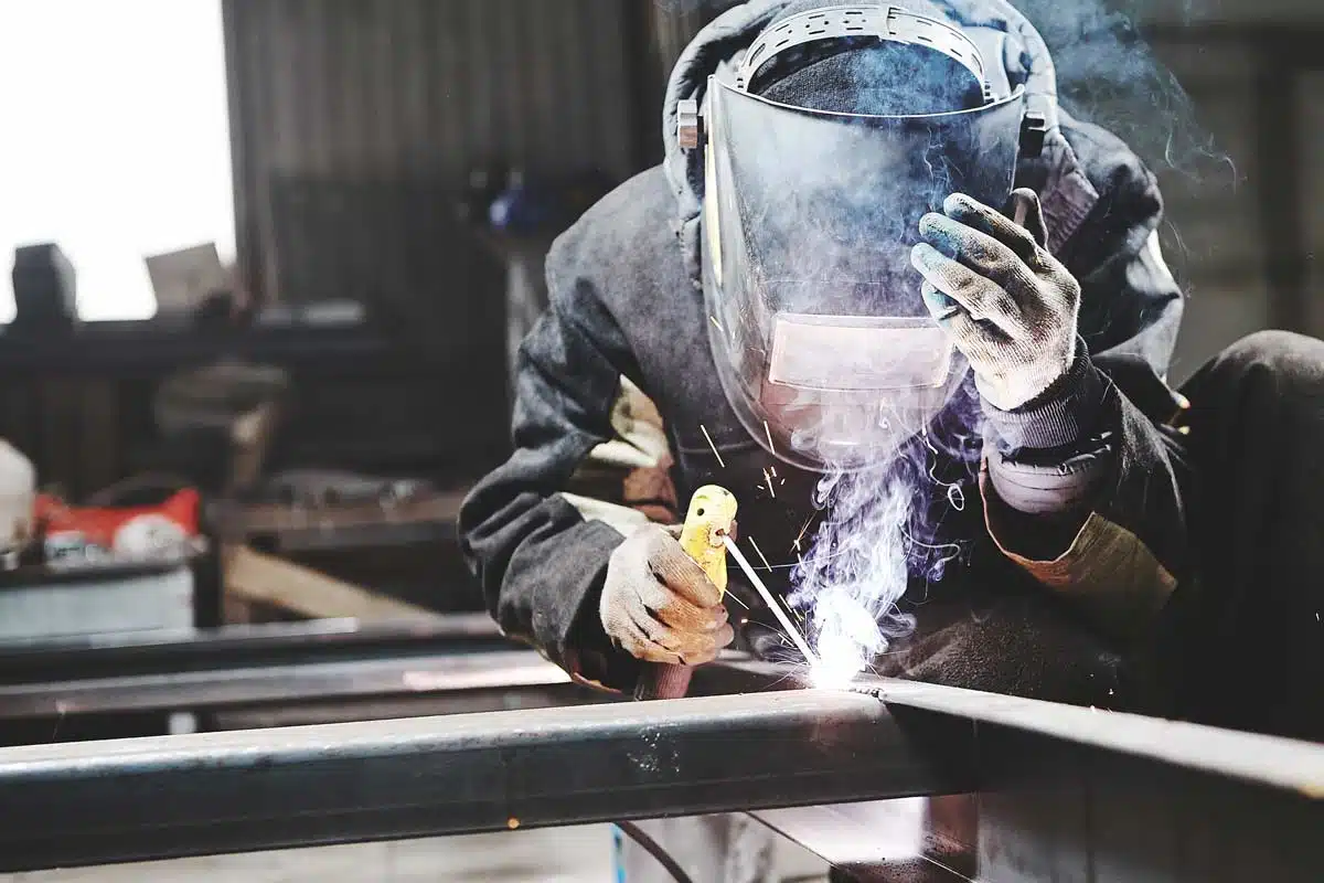 man welding at spike electric
