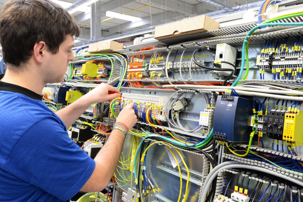 Spike Electric employee examining wiring harnesses