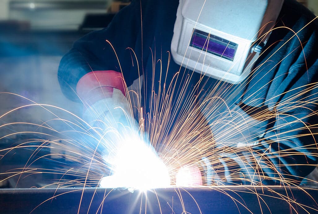 woman welding and offering fabrication services